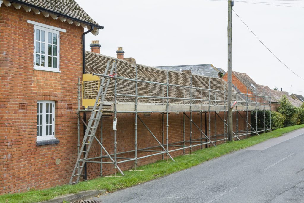 AdobeStock_335661766-roof-repair-scaled-1